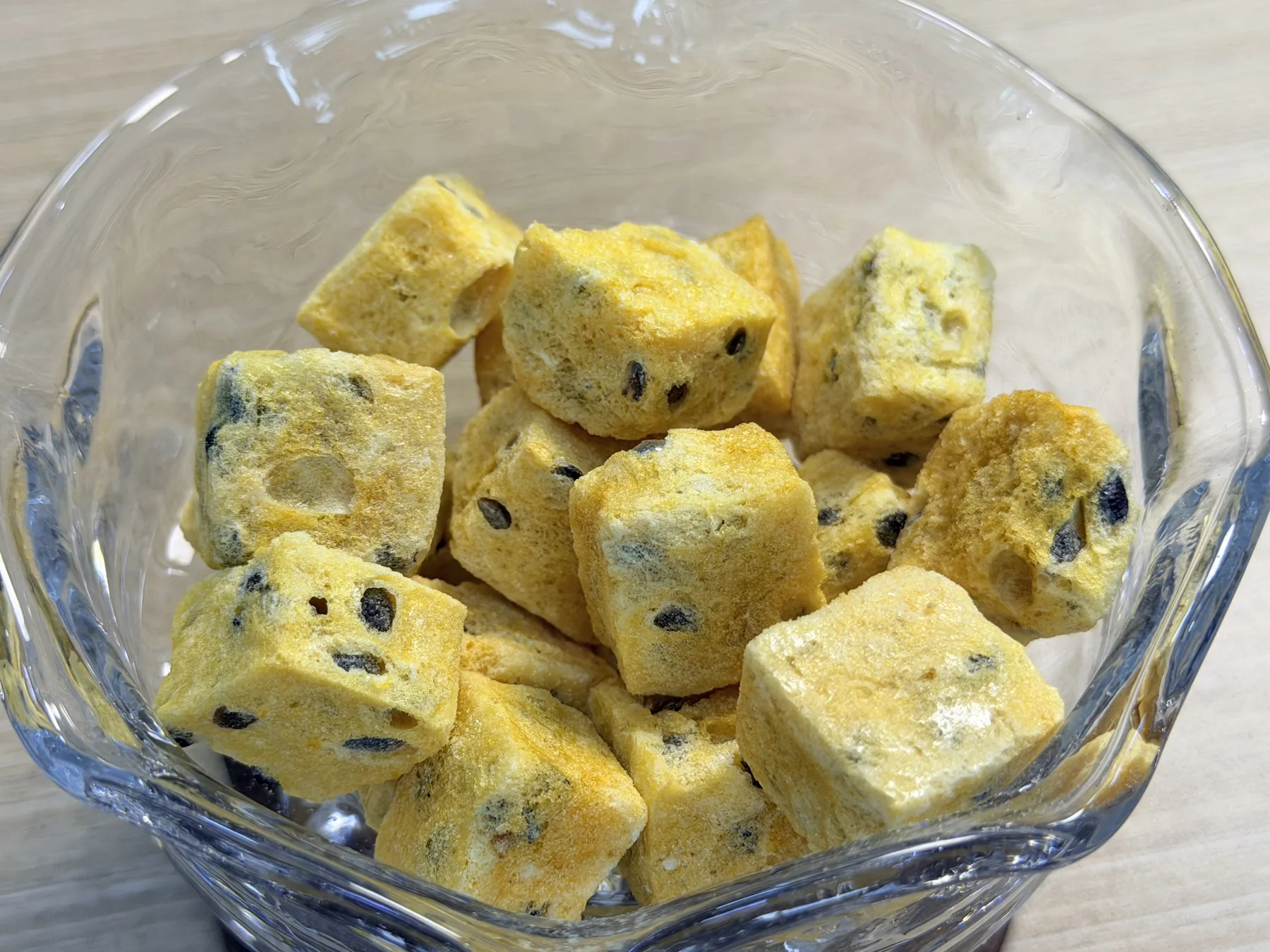 Freeze-dried passion fruit cubes in a glass dish