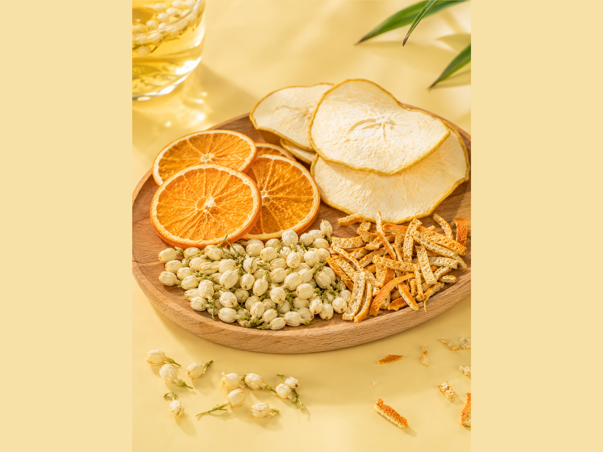 Dried orange, pear, jasmine, and citrus peel arranged as an orange jasmine pear tea blend