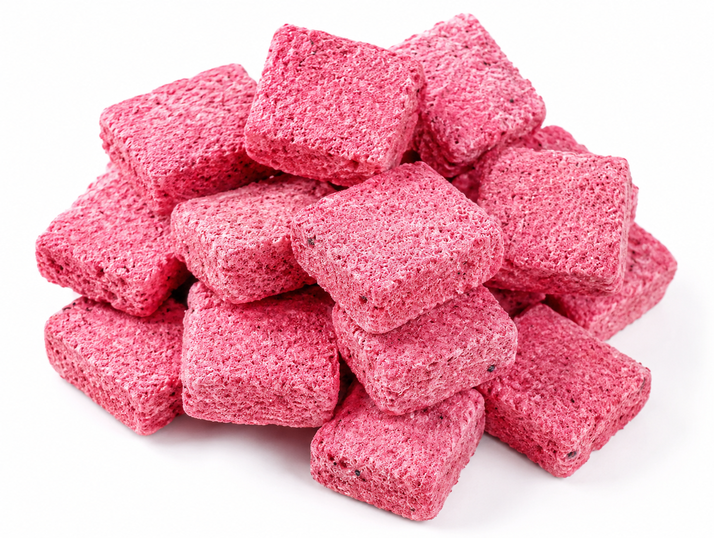 Pink freeze-dried peach oolong tea cubes arranged on a neutral background