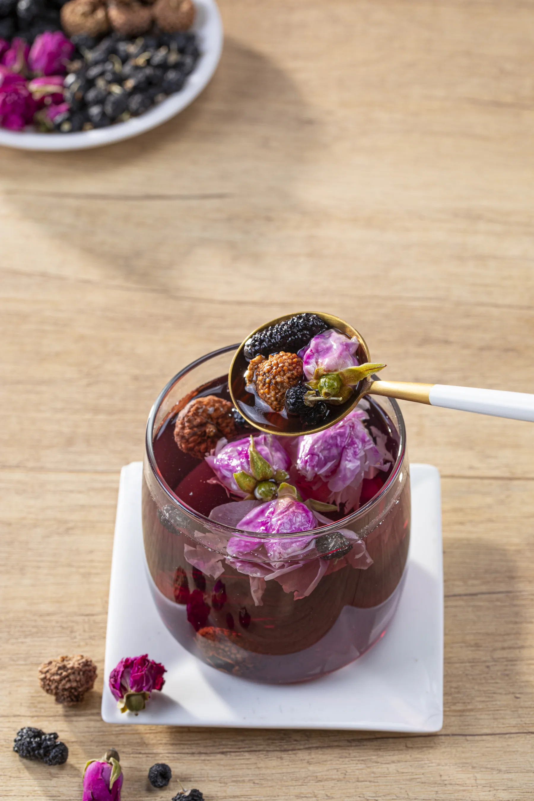 Rose mulberry herbal tea infusion in a glass