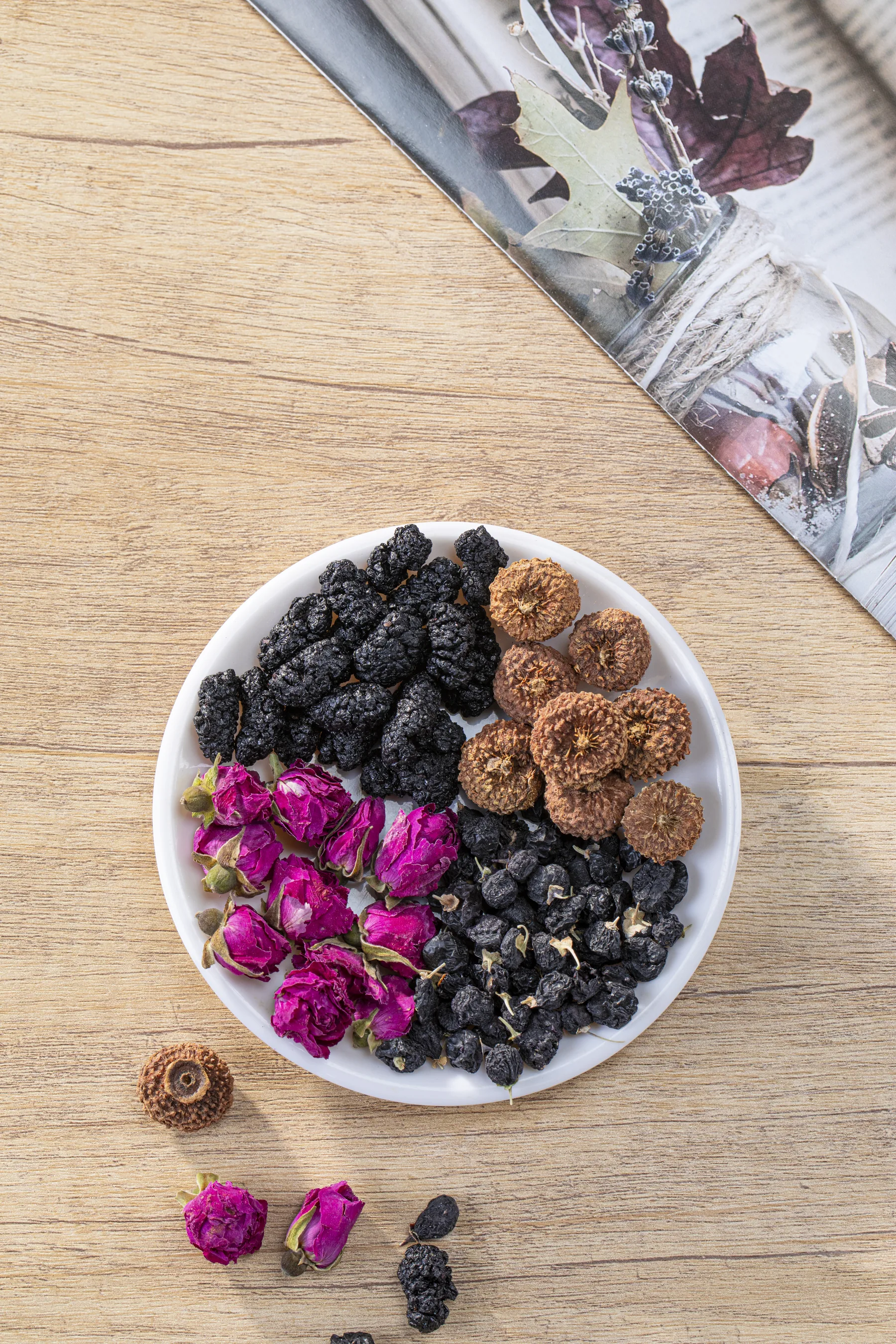 Rose, mulberry, and botanical ingredients arranged in a bowl